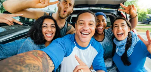 Group of friends smiling in a car